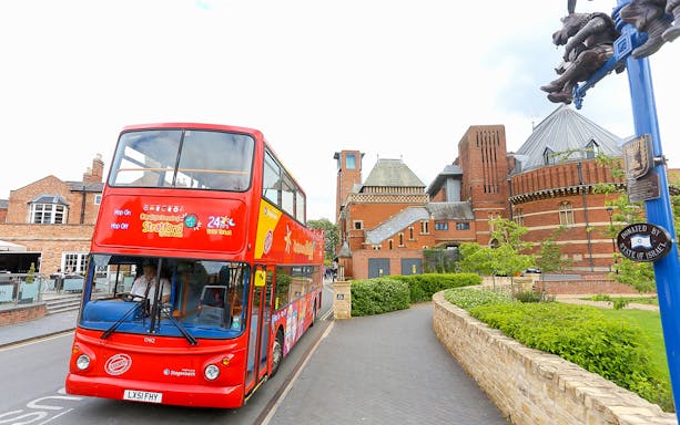 Red double-decker bus on City Sightseeing tour near Royal Shakespeare Theatre, Stratford-upon-Avon.
