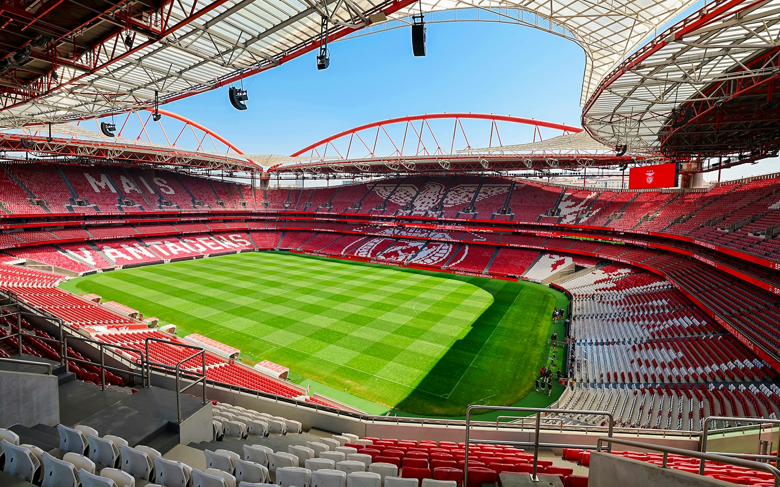 Benfica Stadium view from spectator stand showing green field and red seating.