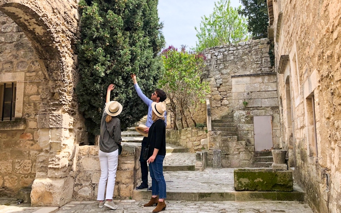 Tourists exploring historic stone architecture in Provence.