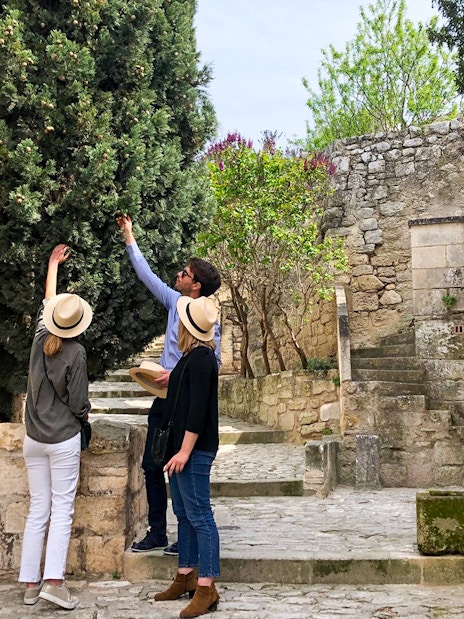 Tourists exploring historic stone architecture in Provence.