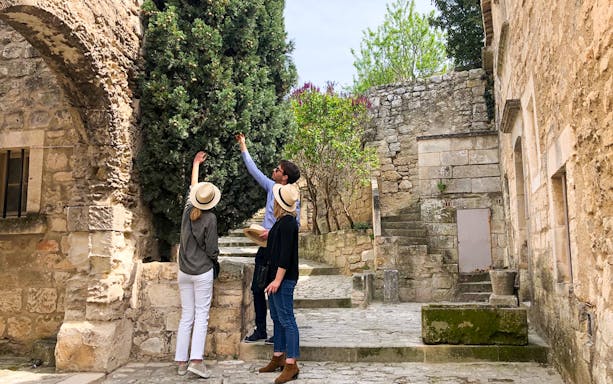 Tourists exploring historic stone architecture in Provence.