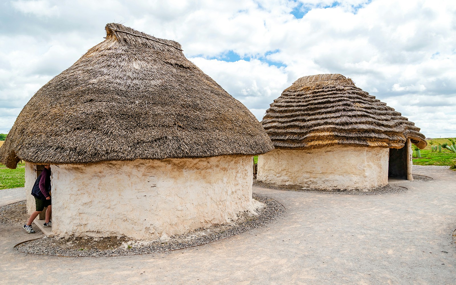 Traditional mud huts with thatched roofs at Stonehenge, England.