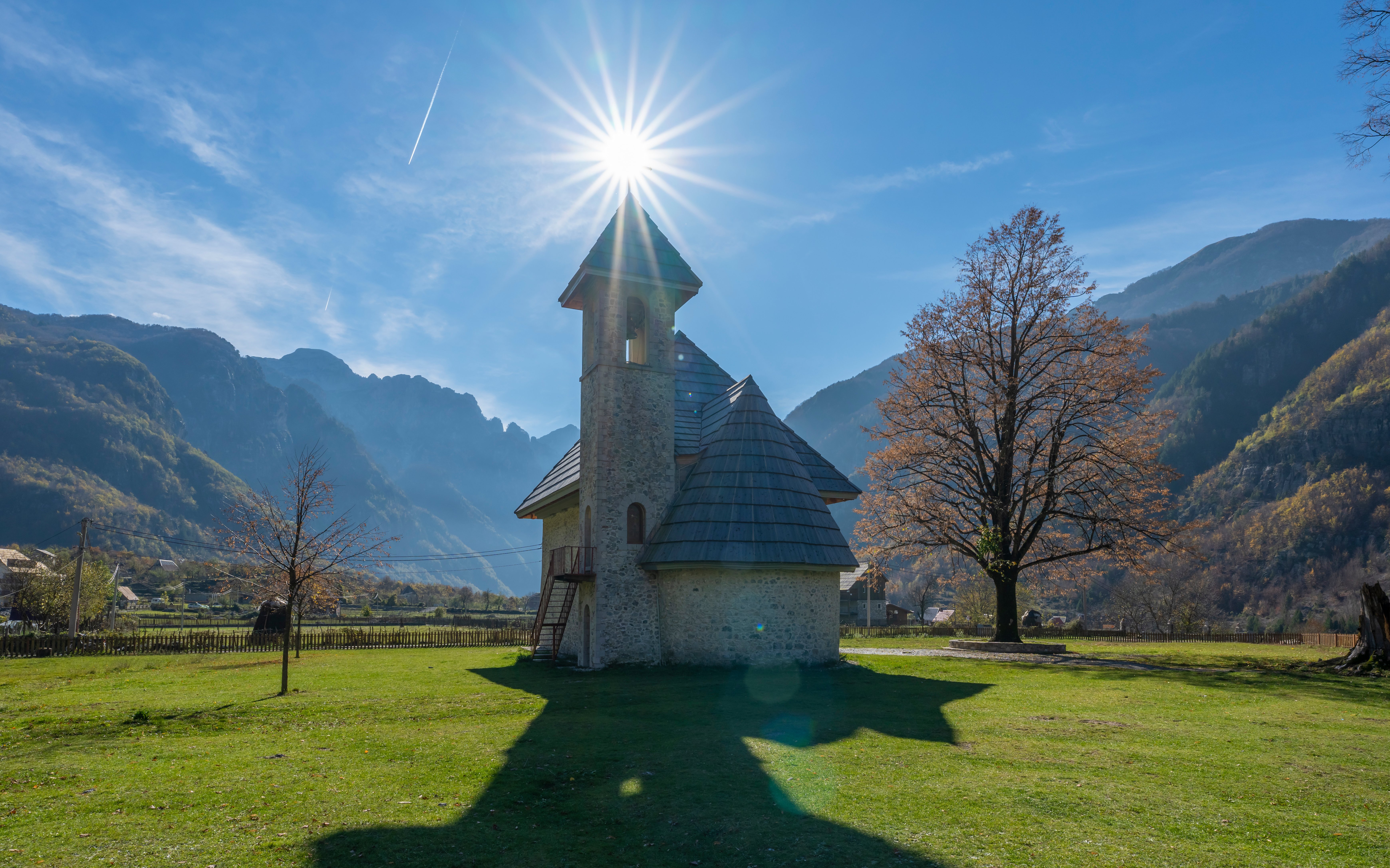Catholic Church of Theth in Albania with mountains in the background.