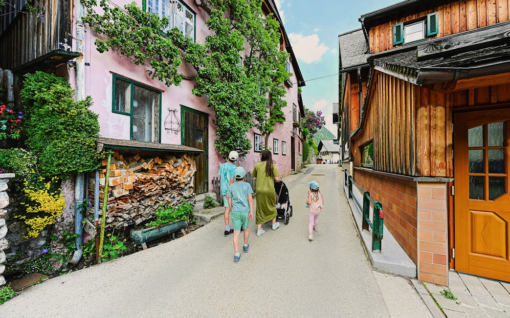 Family walking through a charming street in Hallstatt, Austria, during a day trip from Vienna.
