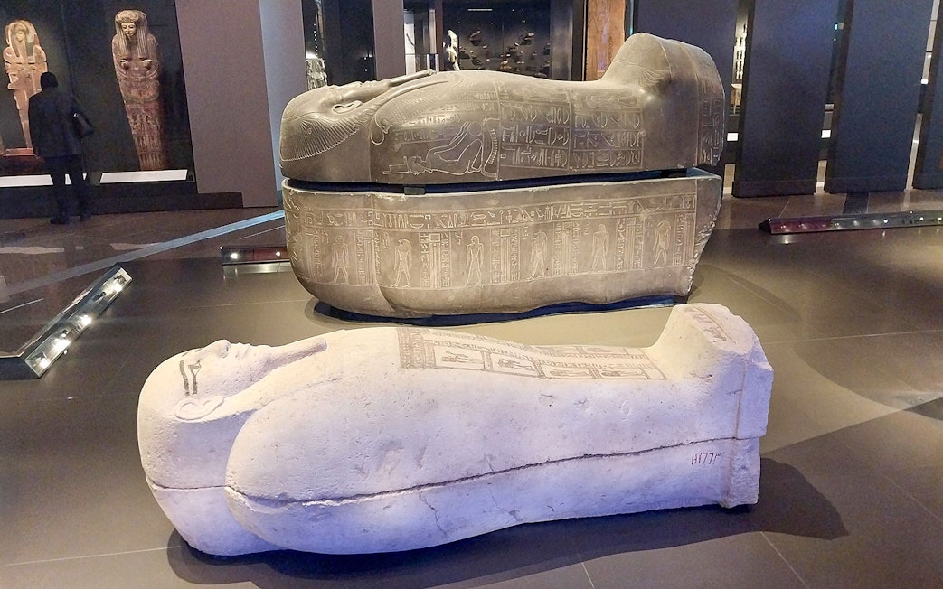 Ancient Egyptian sarcophagi displayed at the Grand Egyptian Museum.