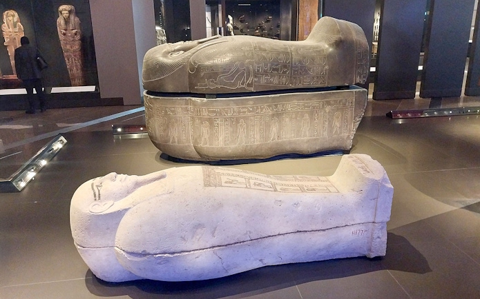 Ancient Egyptian sarcophagi displayed at the Grand Egyptian Museum.