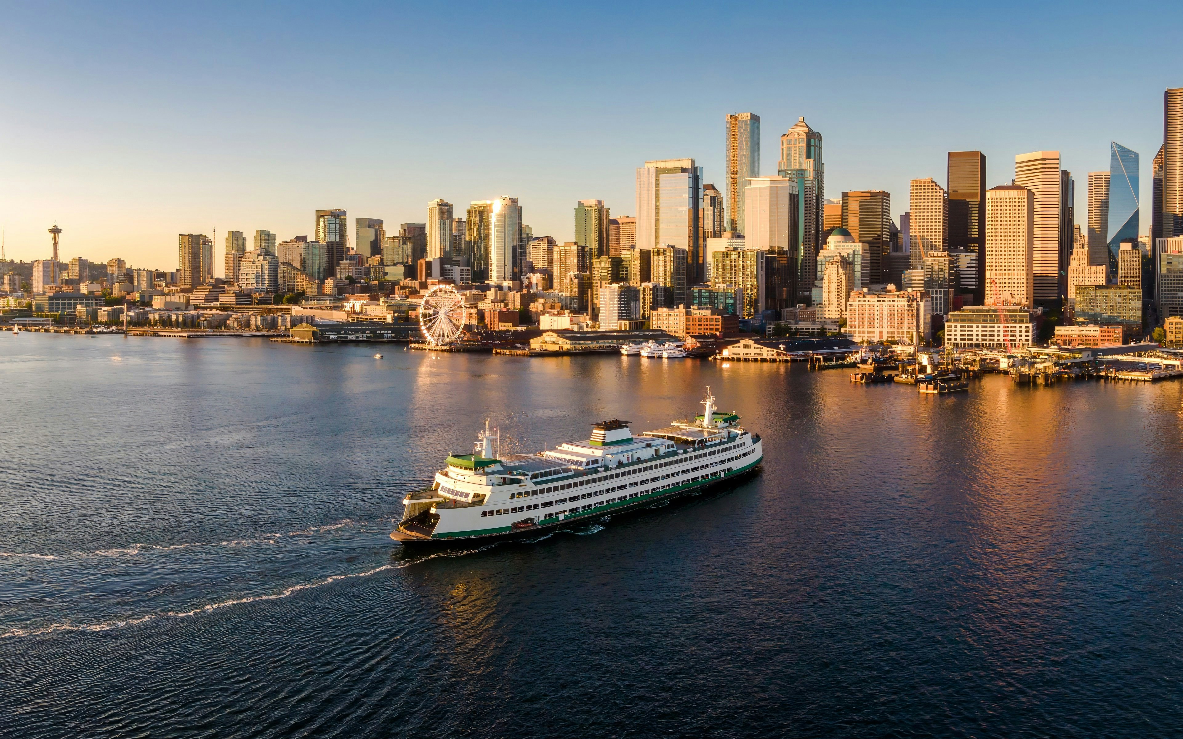 Seattle ferry crossing Puget Sound with city skyline in the background.