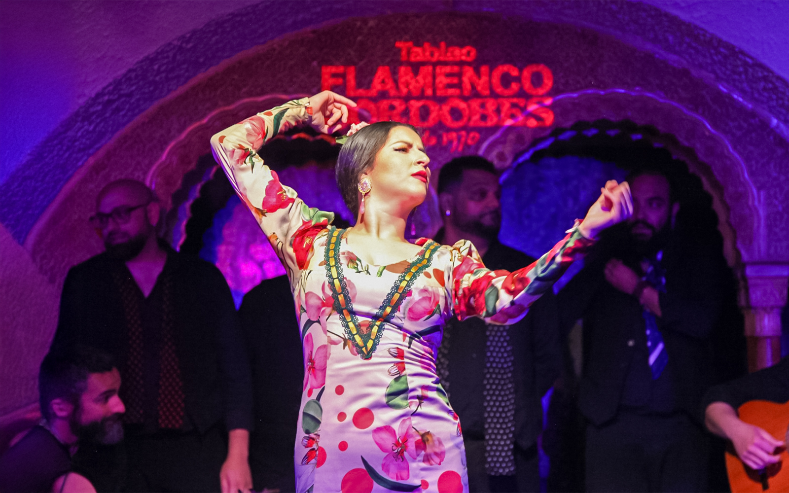 Flamenco dancer performing at Tablao Cordobes in vibrant dress.