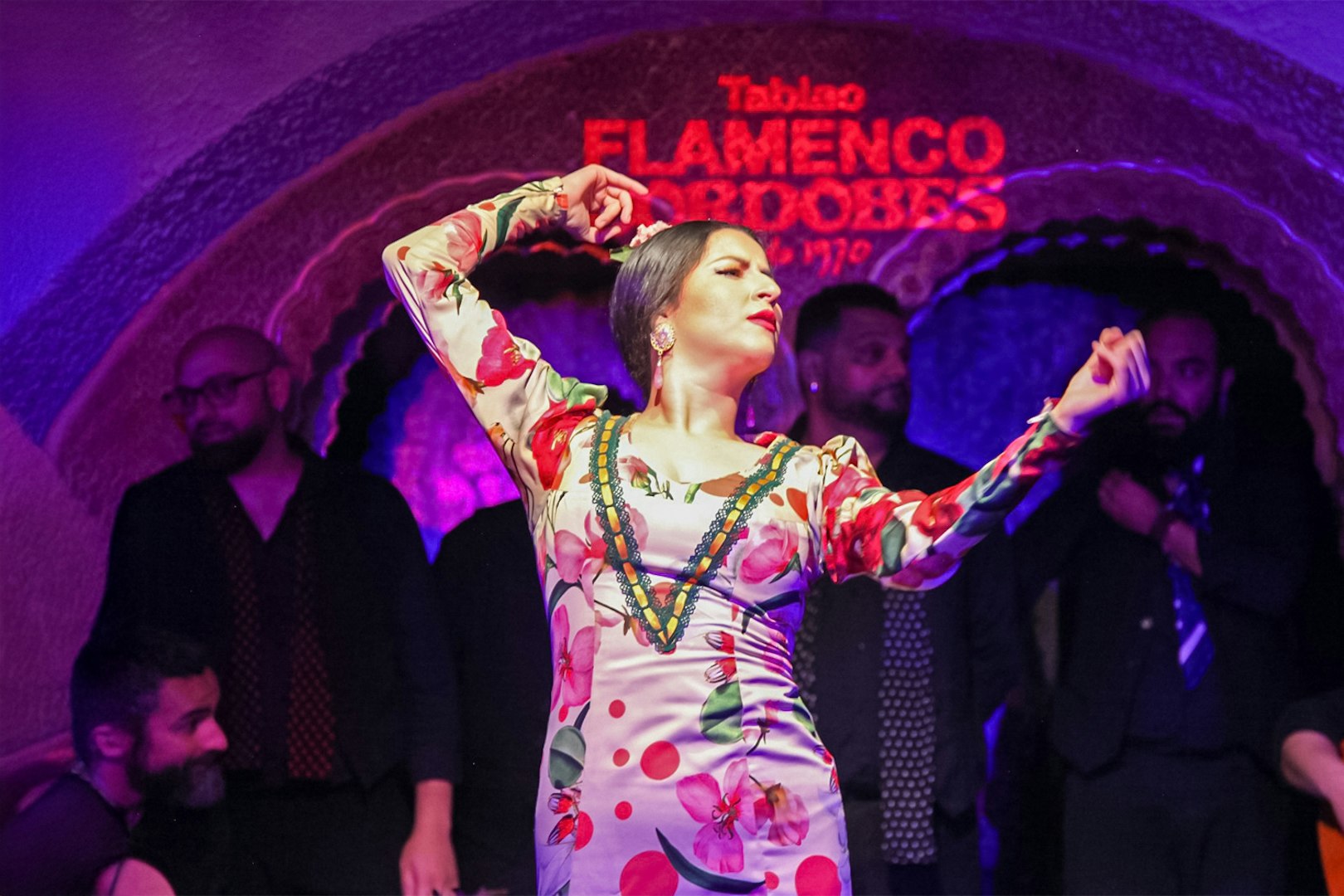 Flamenco dancer performing at Tablao Cordobes in vibrant dress.