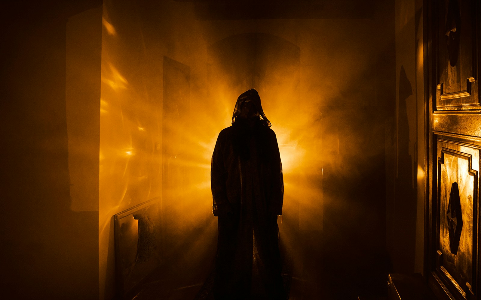 Ghostly figure in a dimly lit horror house hallway.