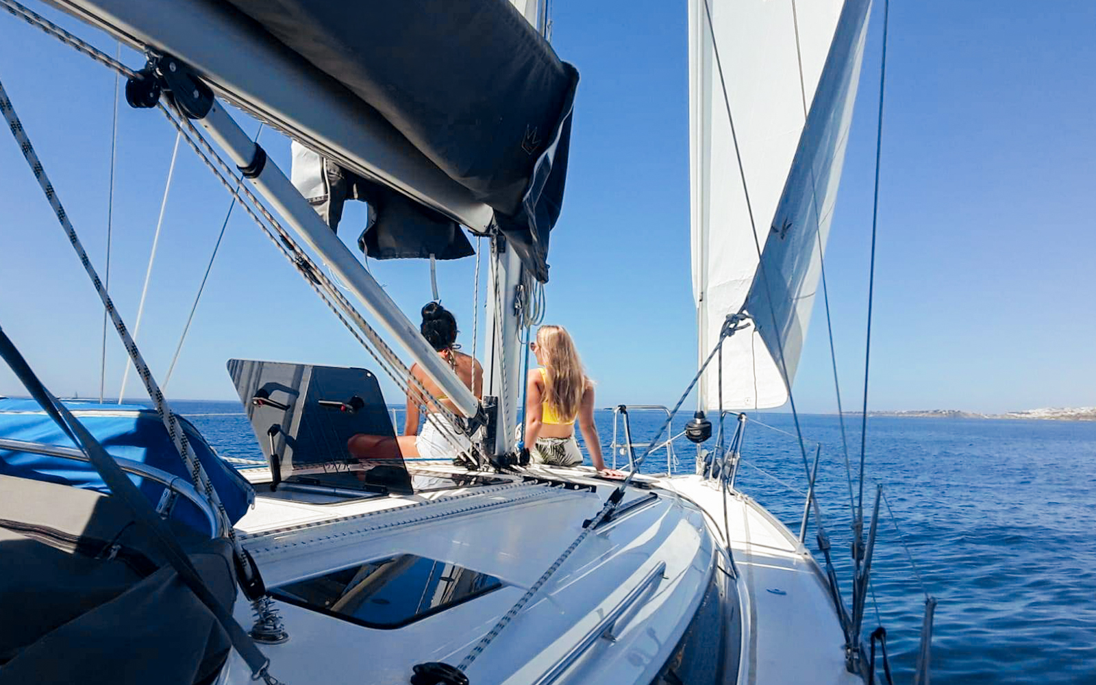 Tourists on a private boat enjoying Lisbon's coastal view.