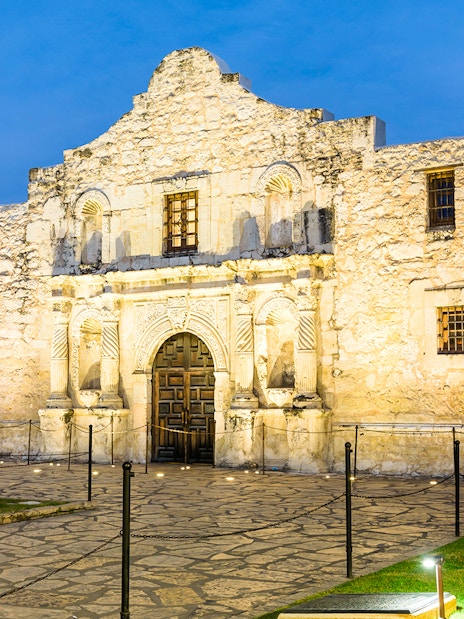 The Alamo Mission facade in San Antonio at dusk.