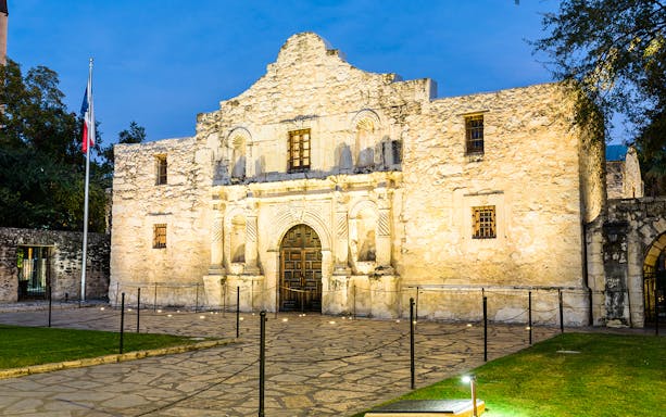 The Alamo Mission facade in San Antonio at dusk.