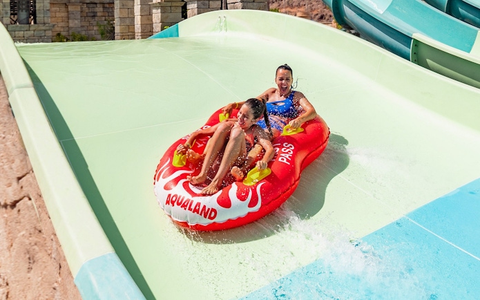 Visitors enjoying a water slide at Aqualand Maspalomas.