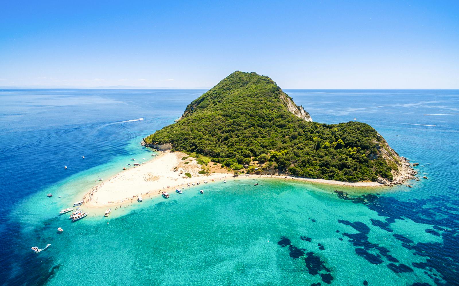 Aerial view of Marathonisi Island with sandy beaches and turquoise waters in Zakynthos, Greece.