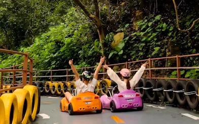 Go-karting on a scenic track surrounded by lush greenery at Gulong Gorge, Guangzhou.
