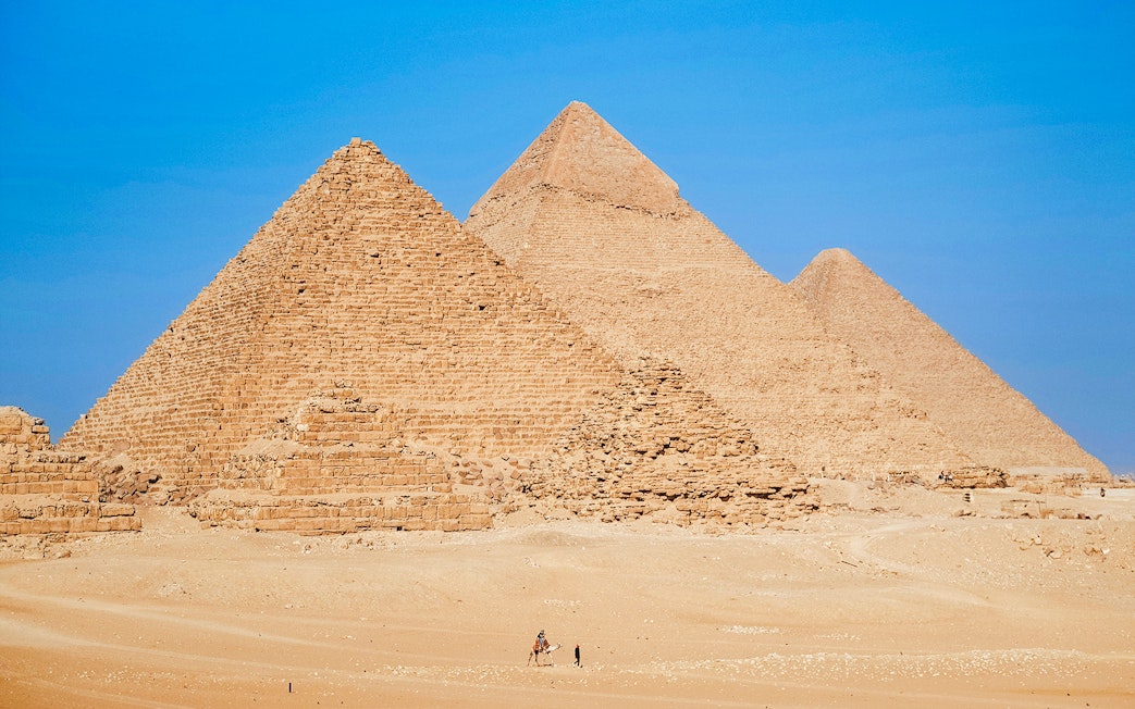 Pyramids of Giza under clear blue sky in Egypt.