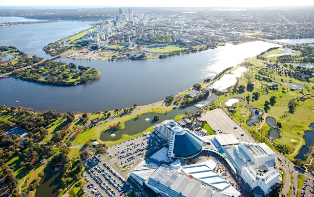 Aerial view of Perth's Optus Stadium and Swan River with city skyline.