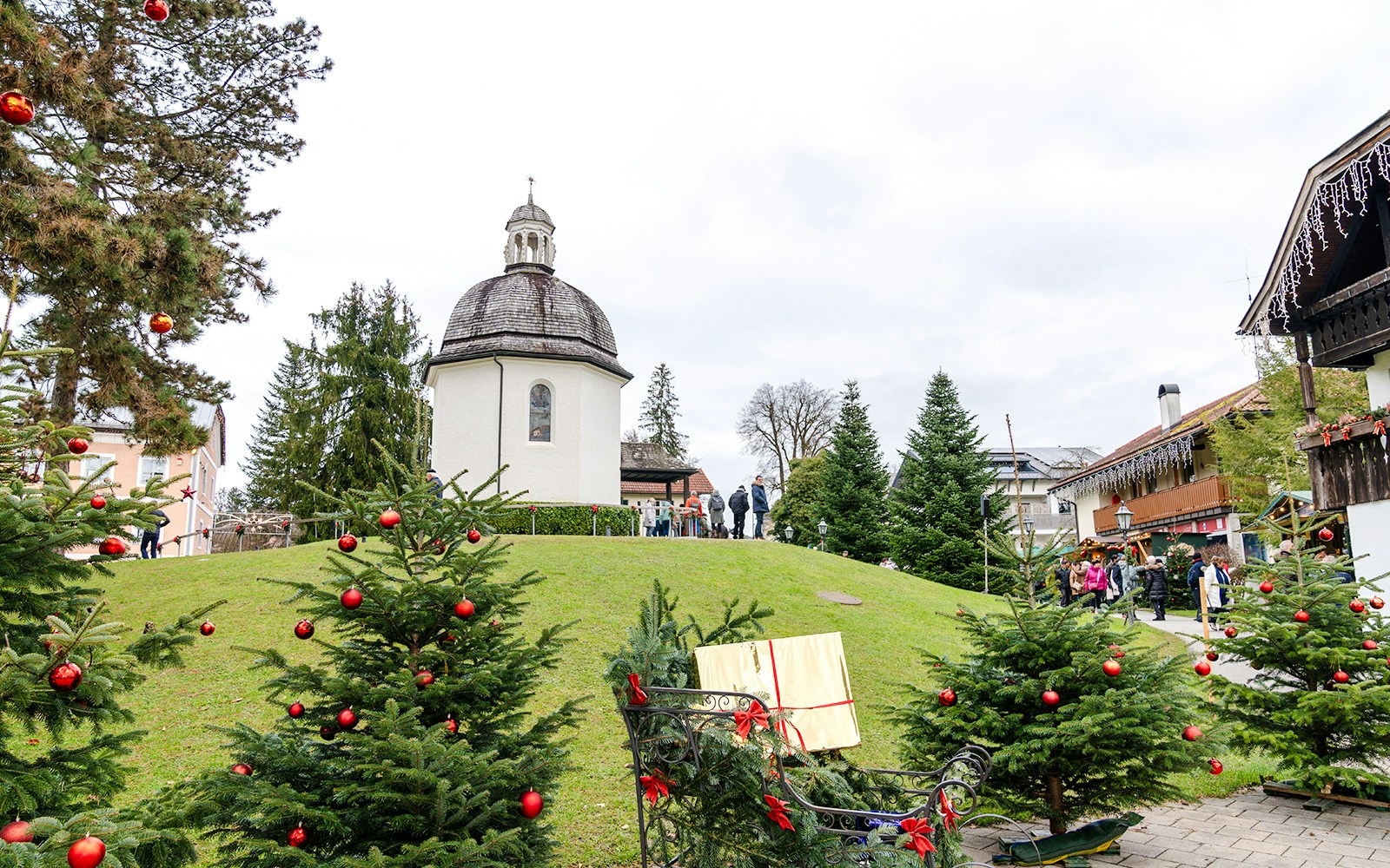 Silent Night Chapel in Oberndorf, Austria, decorated with Christmas trees and ornaments.