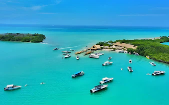 Boats on clear blue water near Rosario Islands, Cartagena, Colombia.