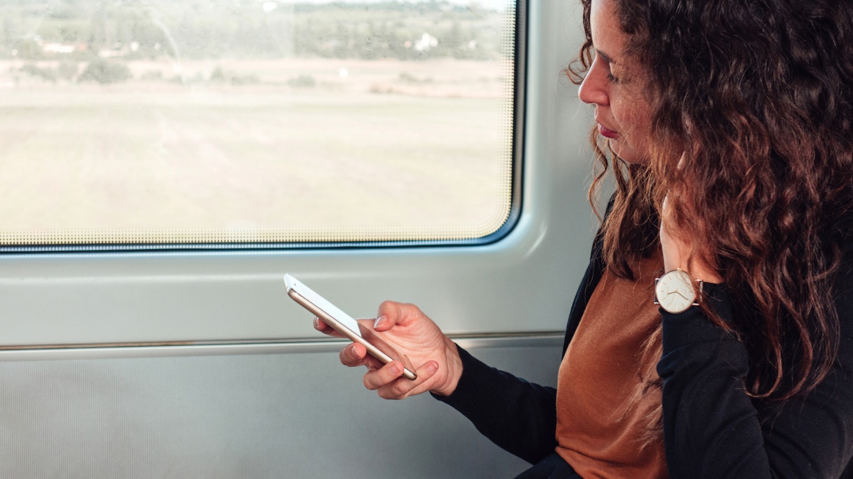 women checking her train timetable on phone app