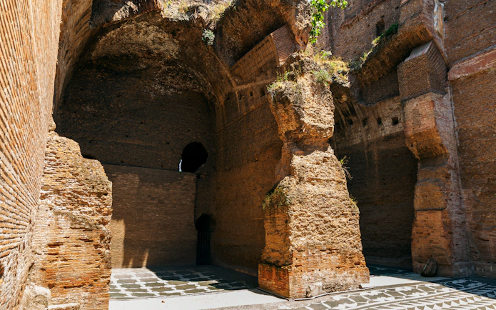 Ancient brick walls and arches of the Roman Baths of Caracalla in Rome, Italy.
