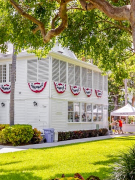 Truman Little White House with festive bunting and ticket booth in Key West.
