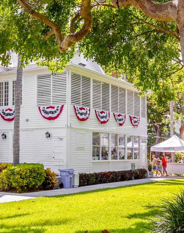 Truman Little White House with festive bunting and ticket booth in Key West.