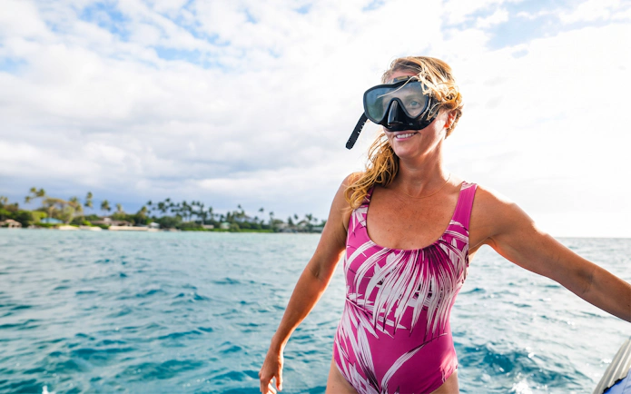 Woman preparing to snorkel on Big Island's Kohala Coast.