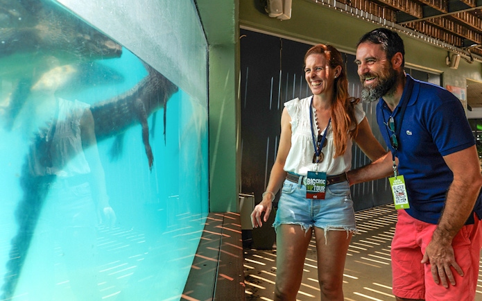 Couple enjoying crocodile view at Crocosaurus Cove, Darwin, Australia.