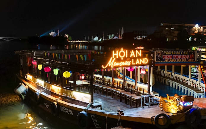 Hoi An Memories Land boat with colorful lanterns at night, Vietnam.