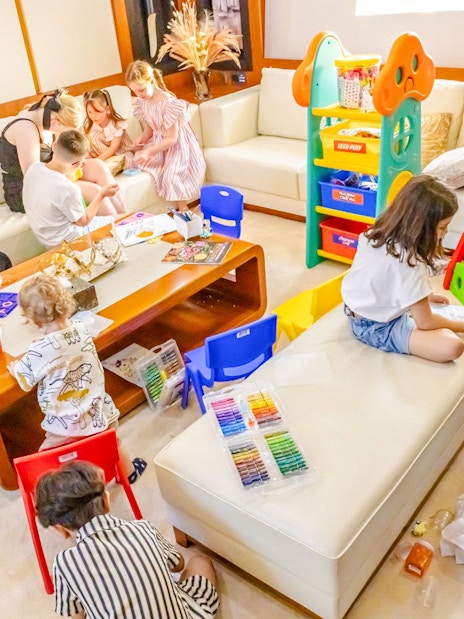 Children playing with toys and books on a yacht cruise in Dubai.