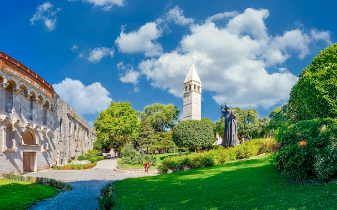 Diocletian's Palace walls and bell tower with statue in Split, Croatia.