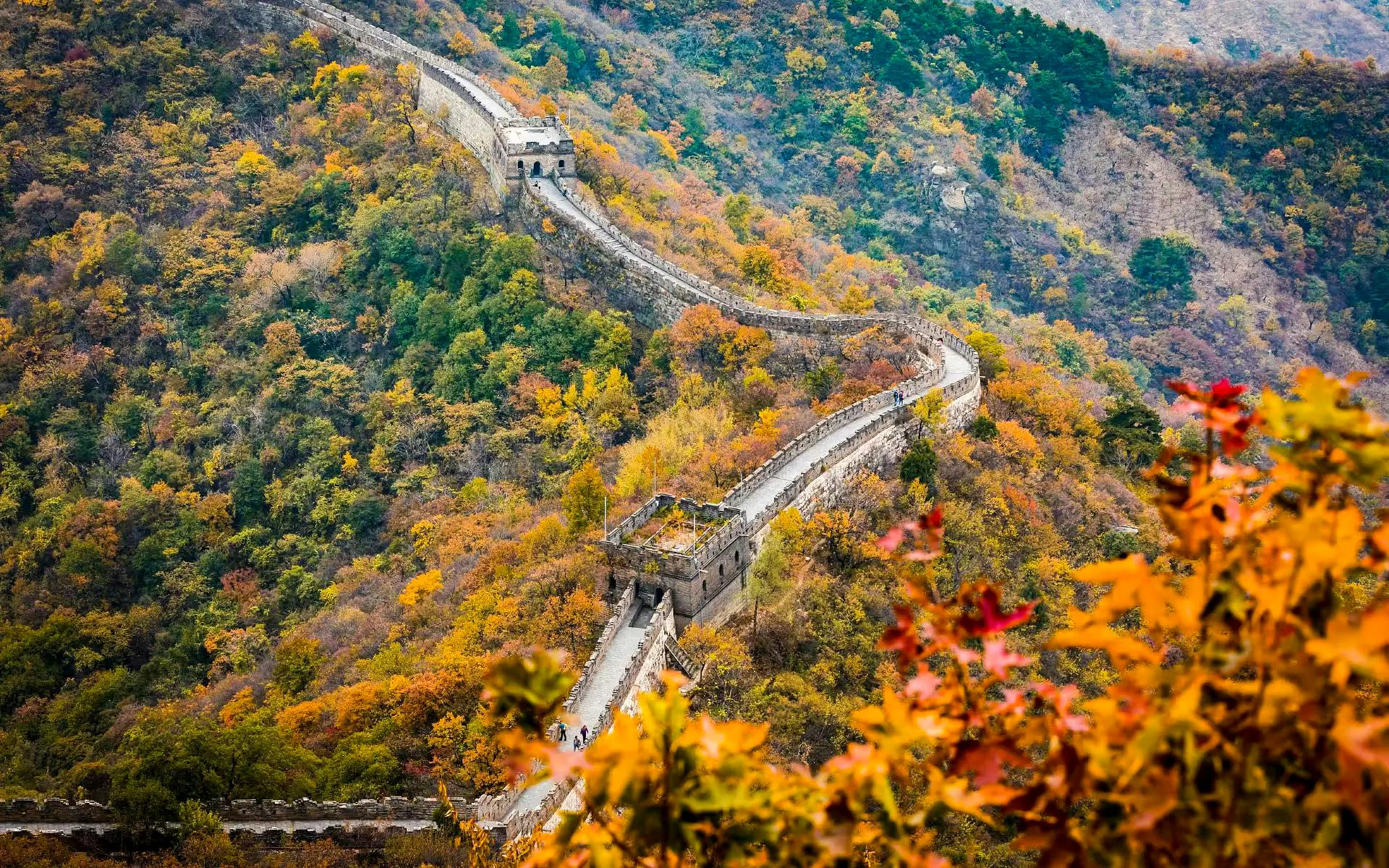 Mutianyu Great Wall winding through autumn foliage in Huairou District, Beijing.