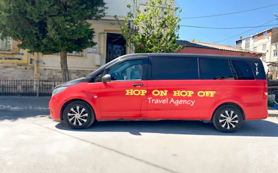 Red VIP Hop On Hop Off tour van parked in Istanbul street.