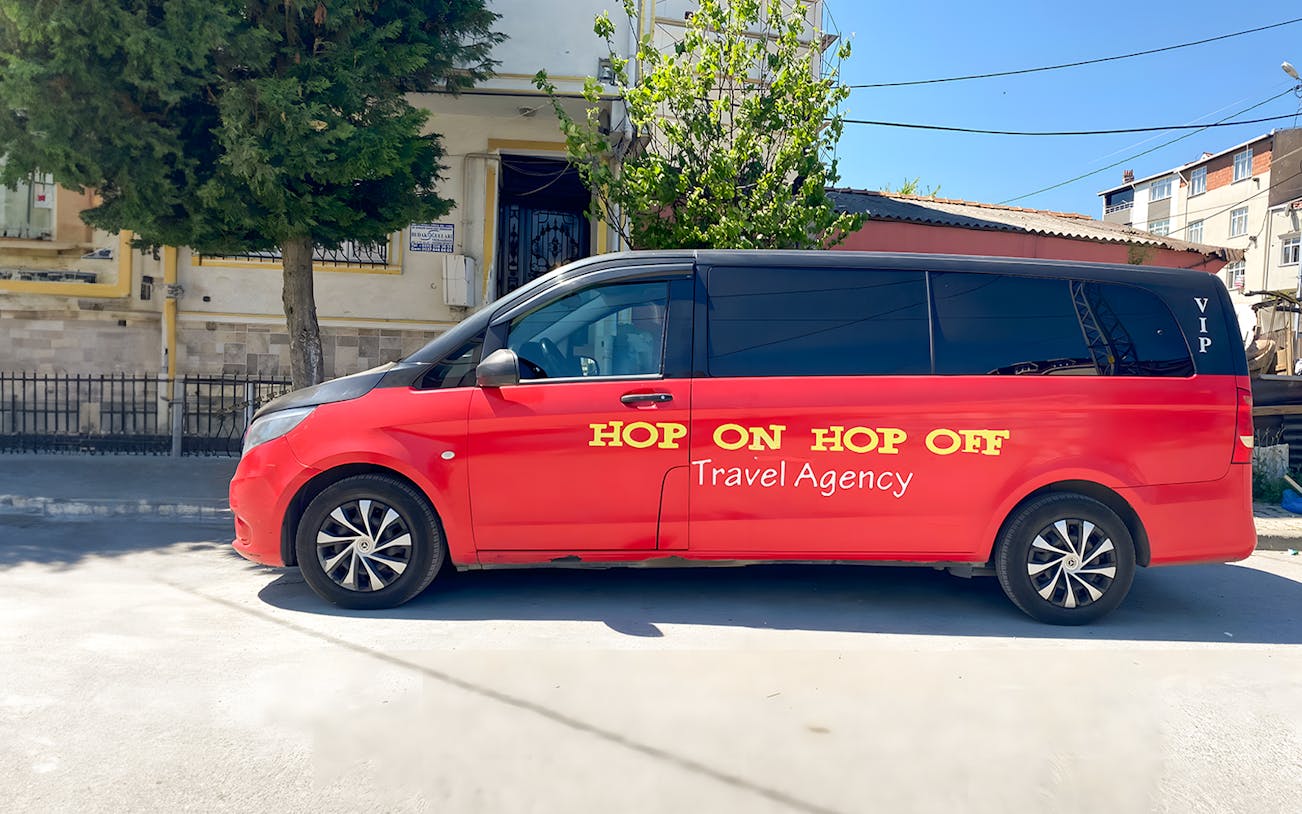 Red VIP Hop On Hop Off tour van parked in Istanbul street.