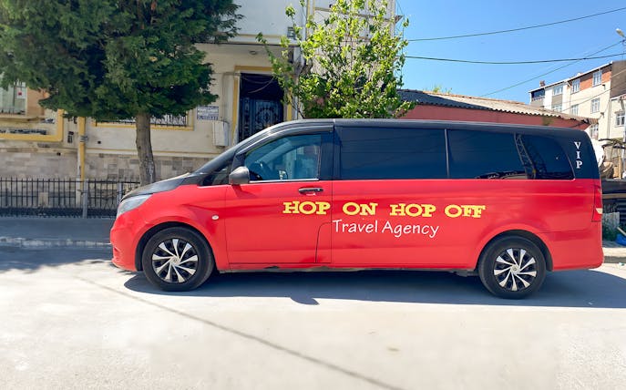 Red VIP Hop On Hop Off tour van parked in Istanbul street.