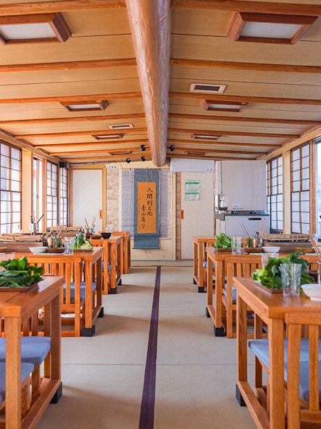 Yakatabune dining setup with tables prepared for hot pot dinner cruise in Japan.