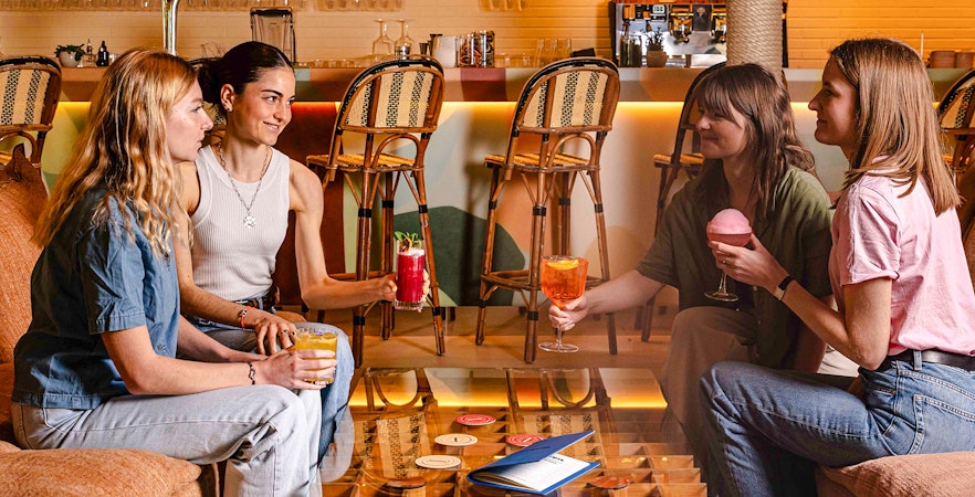 People enjoying drinks at Brasserie Auteuil in a cozy setting.