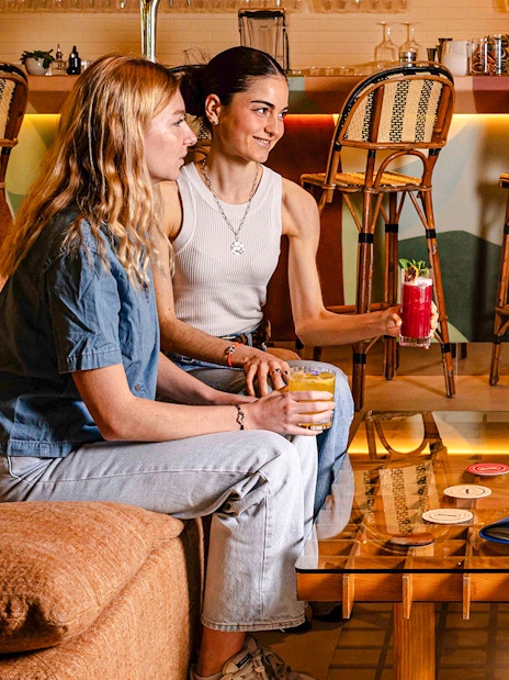 People enjoying drinks at Brasserie Auteuil in a cozy setting.