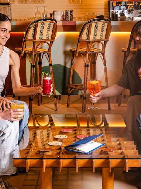 People enjoying drinks at Brasserie Auteuil in a cozy setting.