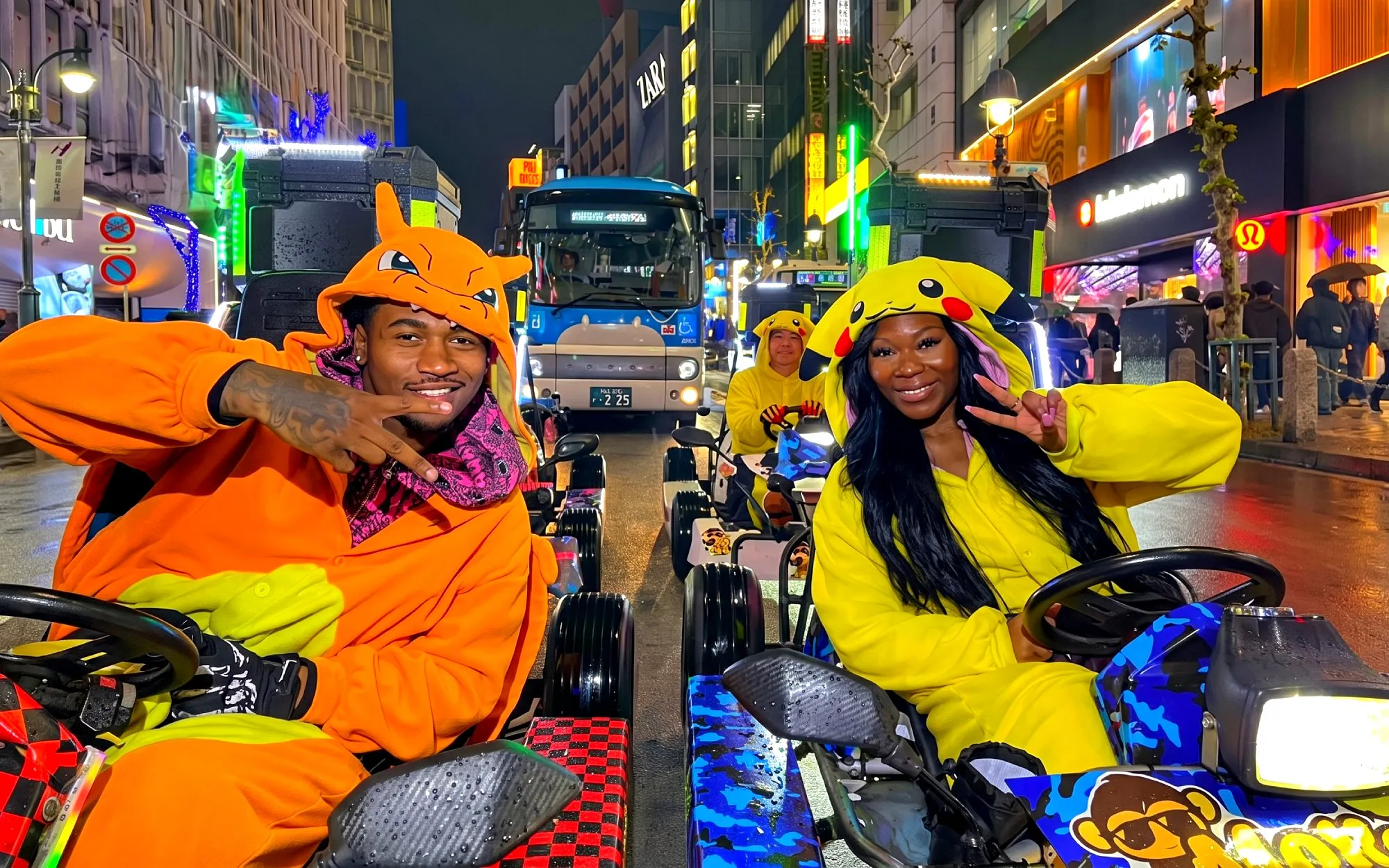 Go-kart riders in character costumes at Shibuya Crossing, Tokyo, during a night tour.