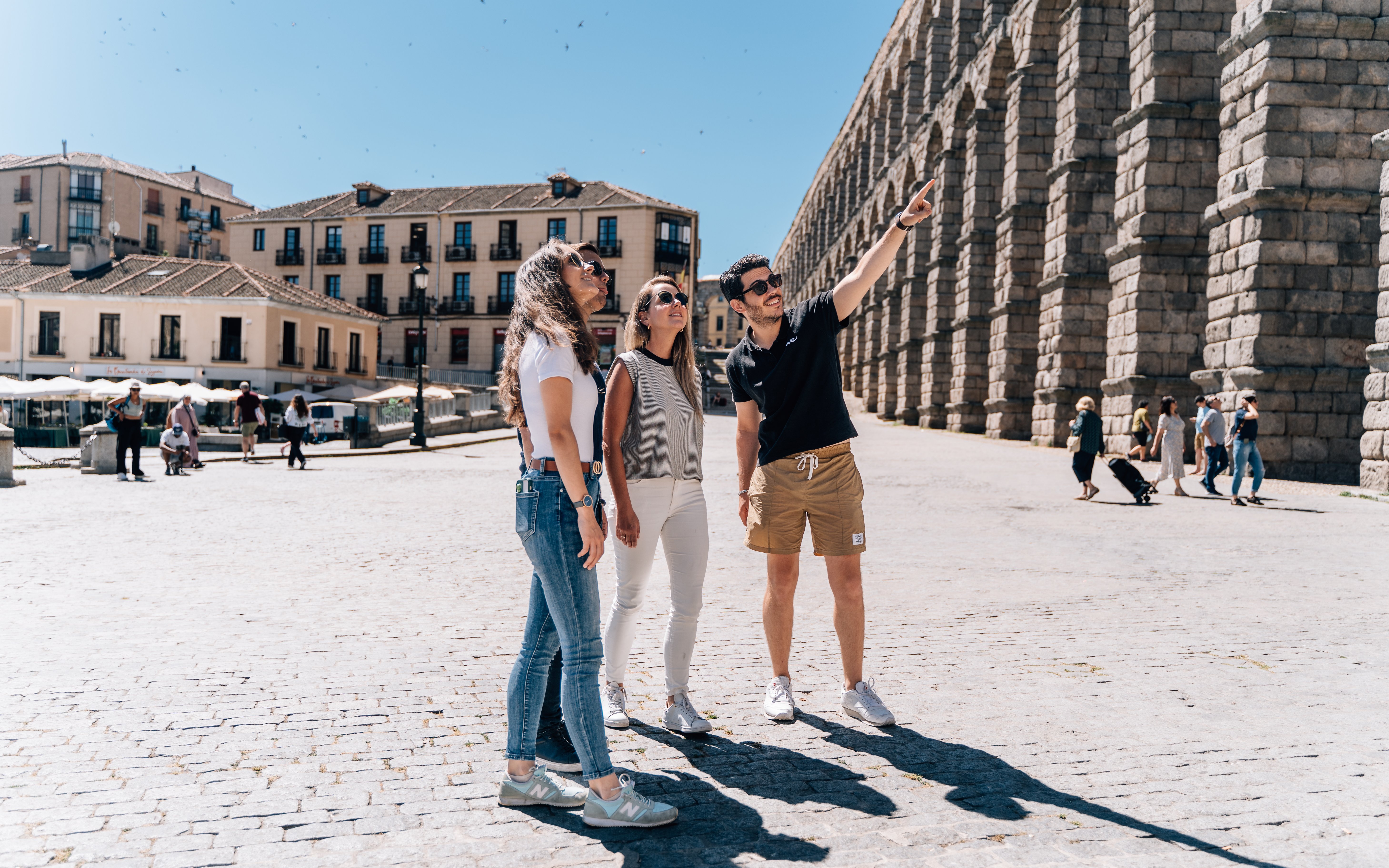 Tourist group with guide at the Aqueduct of Segovia, Spain.