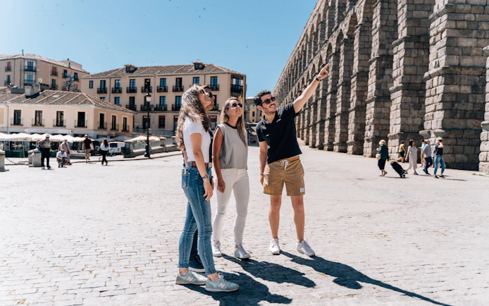 Tourist group with guide at the Aqueduct of Segovia, Spain.