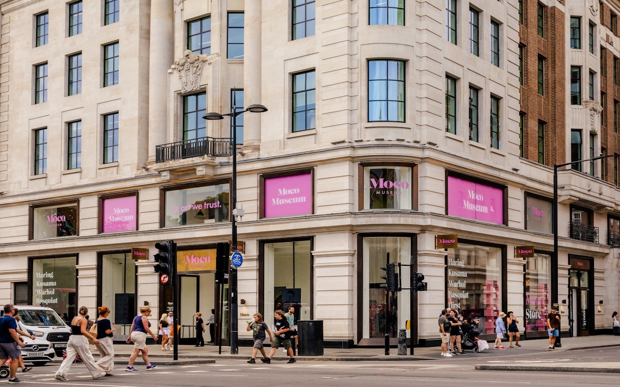 Exteriors of Moco Museum London with people walking by on a busy street corner.
