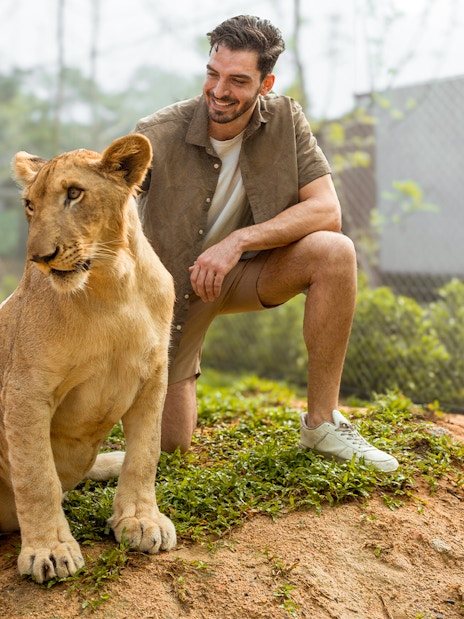 Man interacting with a lion at Lion Land Phuket.