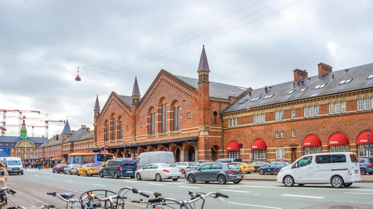 Copenhagen Central Station with red brick facade and busy street scene.