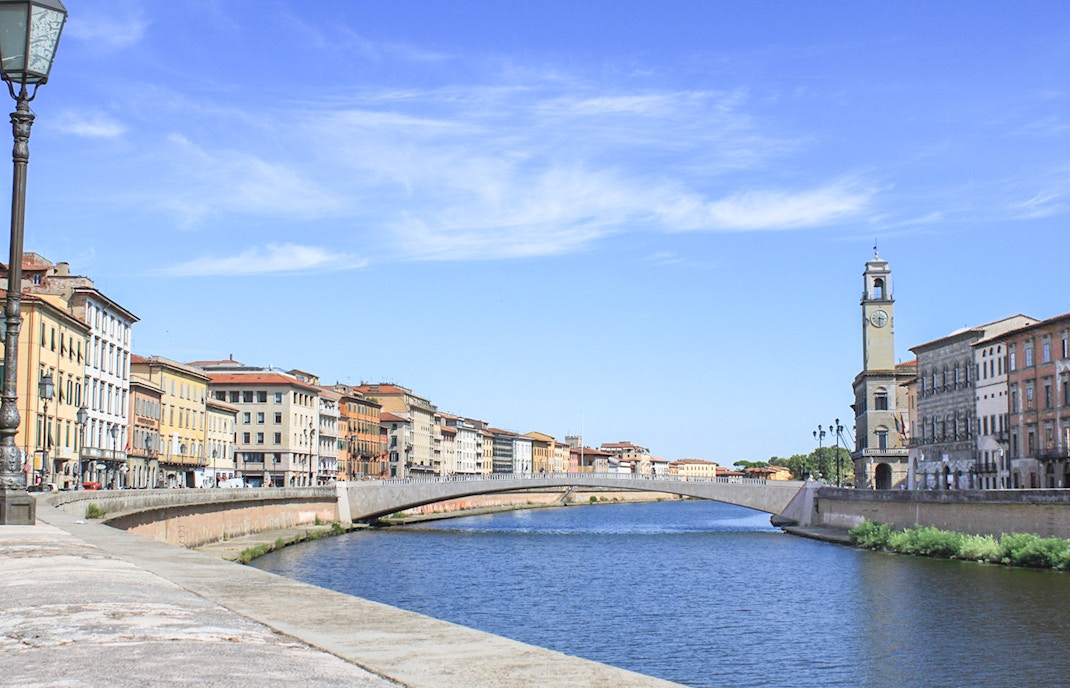 River Arno and historic buildings in Pisa, Italy, near the Leaning Tower tour.