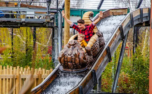 People enjoying a log flume ride at an amusement park.