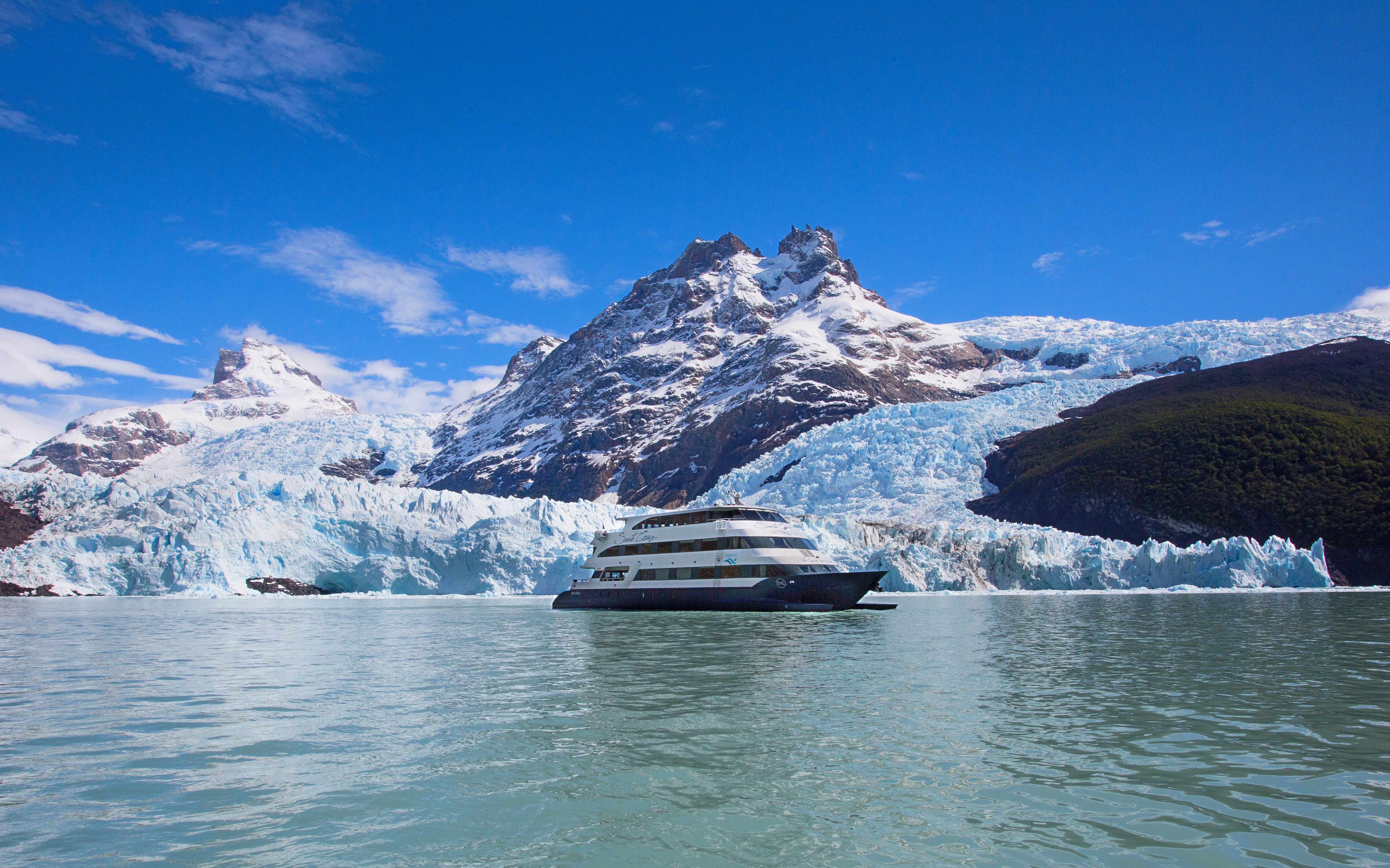 Boat cruising near glacier during Spirit of the Glaciers tour in Patagonia.